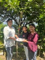 Students tying tying raki on trees